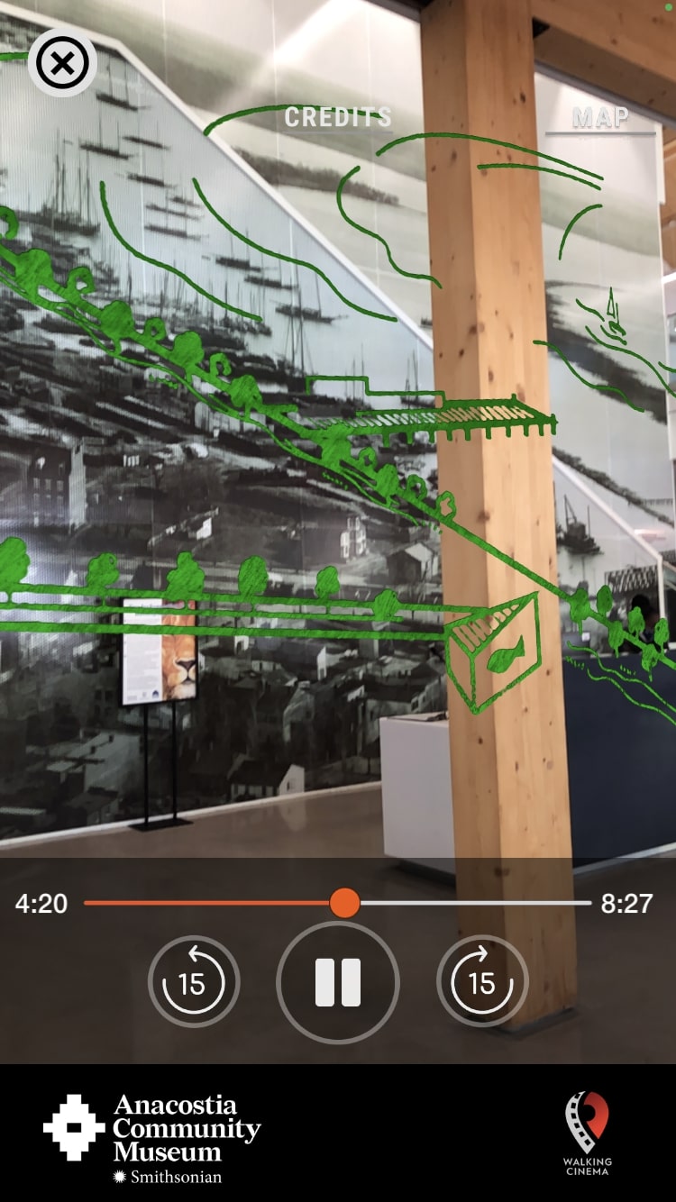 Screenshot of *Before the Bulldozers* app. A phone camera view of a wall mural, with green line-drawing augmented reality illustrations overlapping.