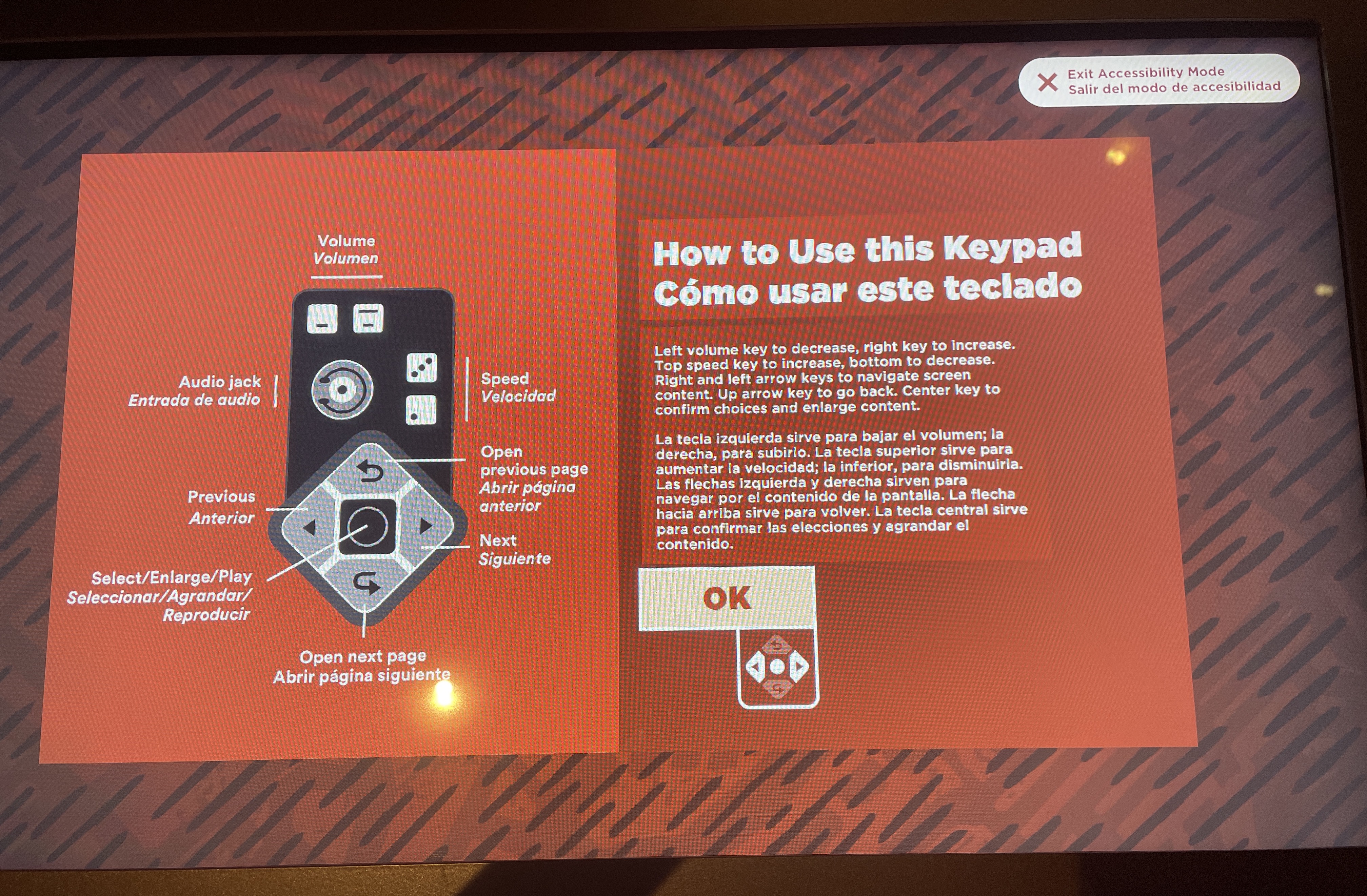 A digital screen with a black and red patterned background depicts instructions in Spanish and English on how to use the keypad controls