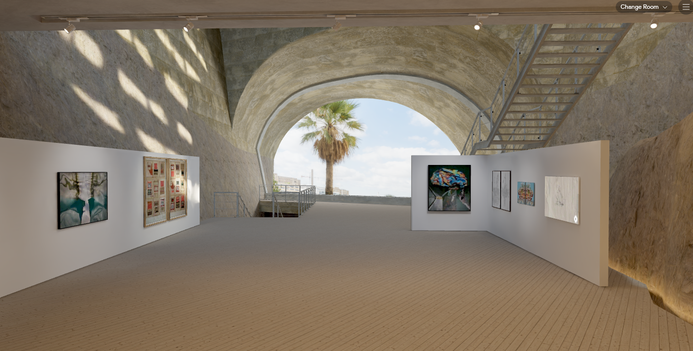 A screenshot of *Between Sea and Land*, a virtual exhibition of art curated by art historian Jo Baring created in collaboration between the Malta International Contemporary Art Space and Vortic. The screenshot shows some of the navigation interface in the top left corner. The screenshot is of the VR Exhibit space, which includes five works of art presented on white walls in a large open room with a window facing outside to a palm tree and the sky. The room has a natural, earth tone color scheme and has brutalist architecture elements contrasting with the artworks.